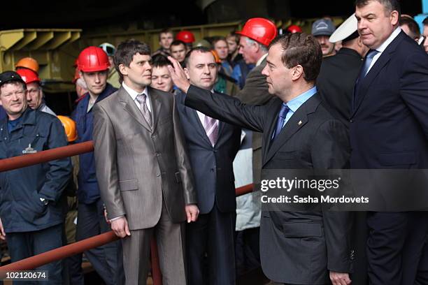 Russian President Dmitry Medvedev and Defense Minister Anatoliy Serdyukov greet workers during a ceremony to launch the multipurpose nuclear...