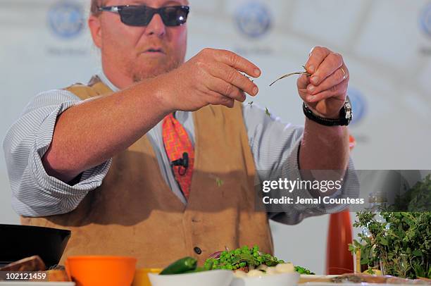 Chef Mario Batali prepares several dishes for the crowd at the world premiere of Volkswagen's new Jetta compact sedan at Times Square on June 15,...