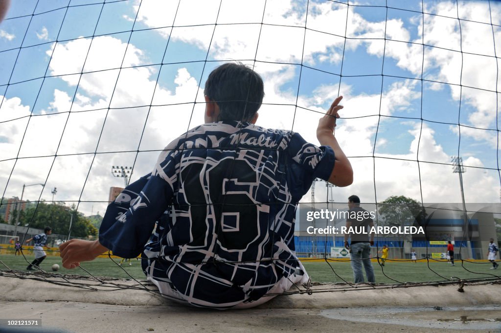 A boy watches as others play during the