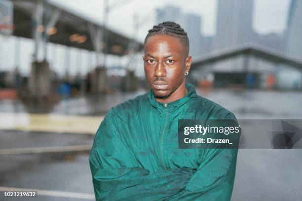 portrait of african american man exercising on rainy day - 90s stock pictures, royalty-free photos & images