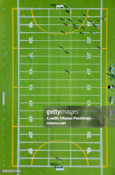 top-down aerial view with tilt-shift effect onto a green american football field - american football field overhead stock pictures, royalty-free photos & images