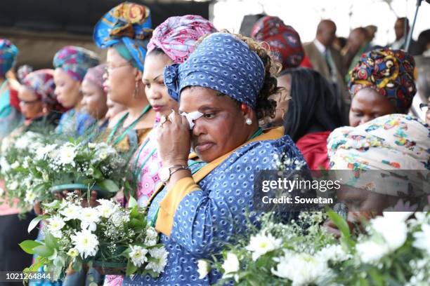 Widows and family members of the 34 slain miners gather to observe the sixth anniversary of the Marikana massacre on August 16, 2018 in Rustenburg,...