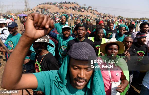 Miners sing and chant gather during an event to commemorate the sixth anniversary of the Marikana massacre on August 16, 2018 in Rustenburg, South...
