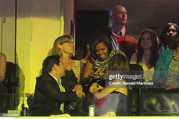 First Lady Michelle Obama visits with fans from a suite during Game Six of the 2010 NBA Finals between the Boston Celtics and the Los Angeles Lakers...