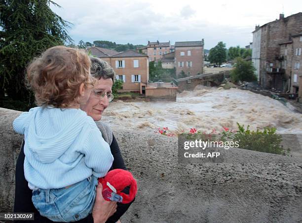 Woman and a child looks at Nartuby river in flood in the aftermath of flooding in a western district of the French south eastern city of...