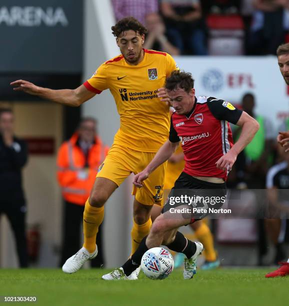 Liam Manderville of Morecambe looks to control the ball under pressure from Matt Crooks of Northampton Town during the Sky Bet League Two match...