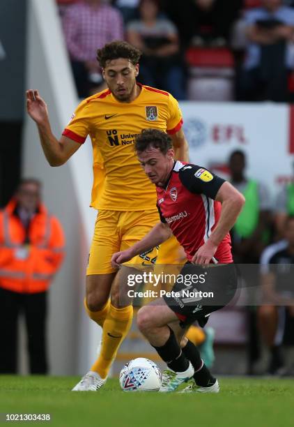 Liam Manderville of Morecambe looks to control the ball under pressure from Matt Crooks of Northampton Town during the Sky Bet League Two match...