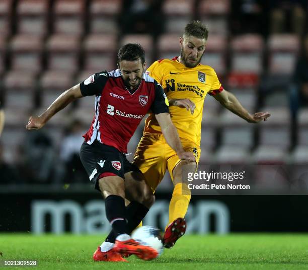 Aaron Wildig of Morecambe contests the ball with Sam Foley of Northampton Town during the Sky Bet League Two match between Morecambe and Northampton...