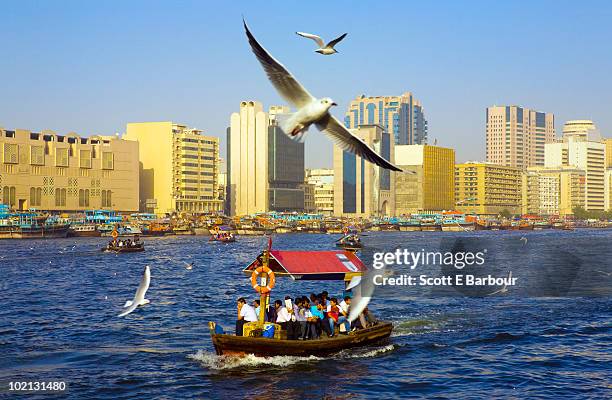 an abra (water taxi) on dubai creek - dubai creek stock pictures, royalty-free photos & images