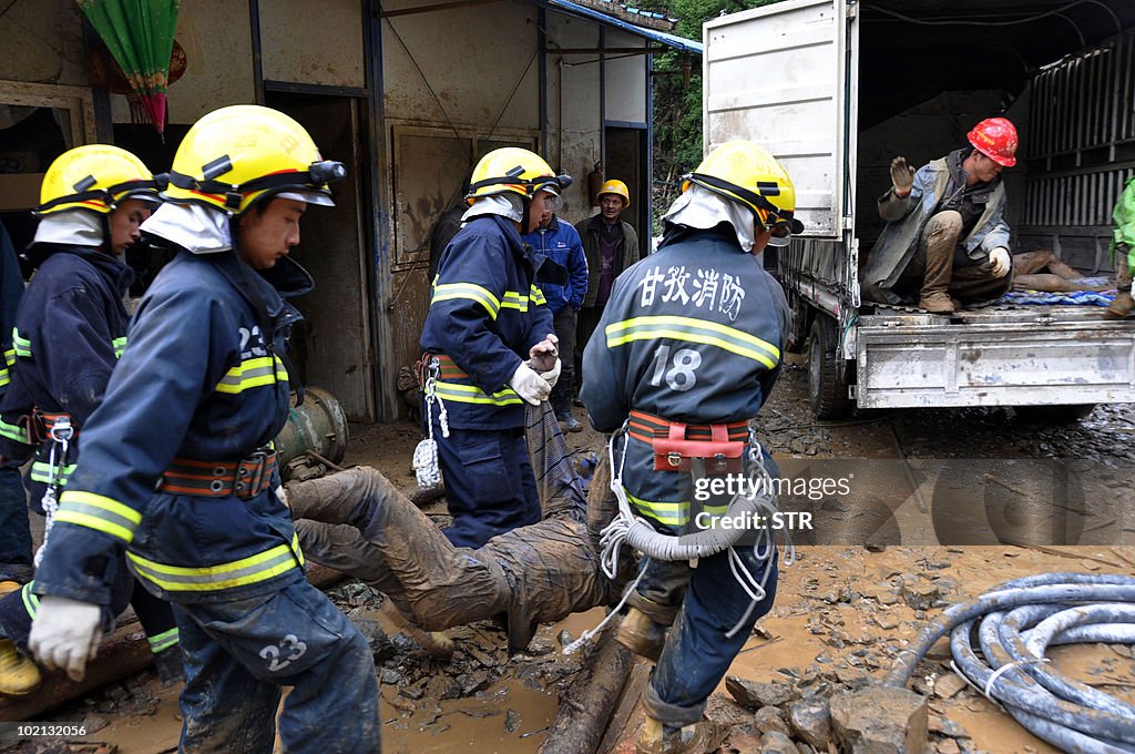 Chinese rescuers remove the bodies of vi