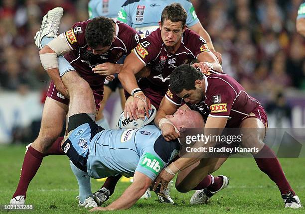 Michael Weyman of the Blues is tackled during game two of the ARL State of Origin Series between the New South Wales Blues and the Queensland Maroons...