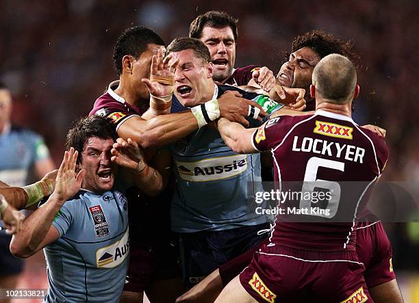 Nathan Hindmarsh and Luke O'Donnell of the Blues are involved in a fight with Maroons players after a spear tackle on Darius Boyd of the Maroons...