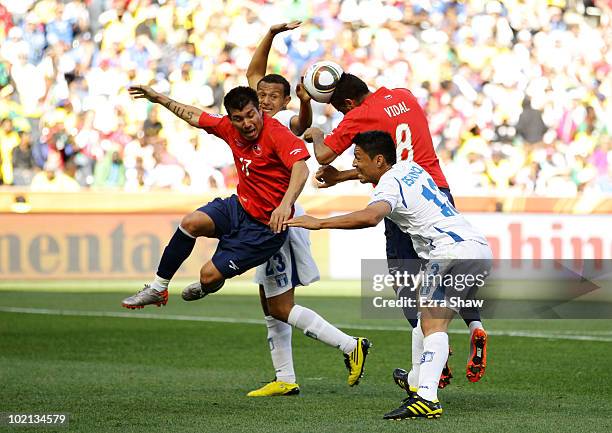 Gary Medel and Arturo Vidal of Chile tussle with Sergio Mendoza and Roger Espinoza of Honduras during the 2010 FIFA World Cup South Africa Group H...