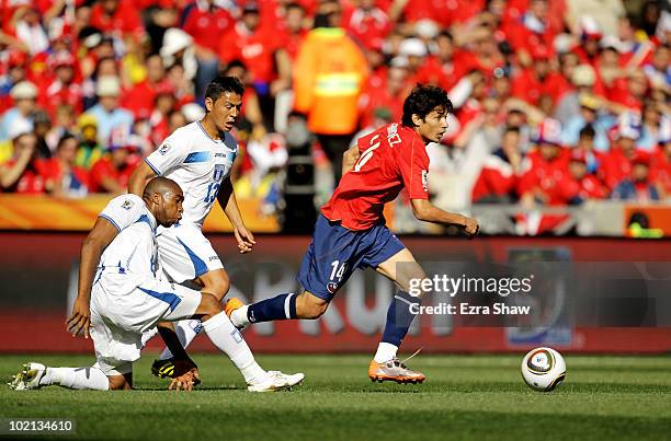 Matias Fernandez of Chile rides the tackle of Wilson Palacios of Honduras during the 2010 FIFA World Cup South Africa Group H match between Honduras...