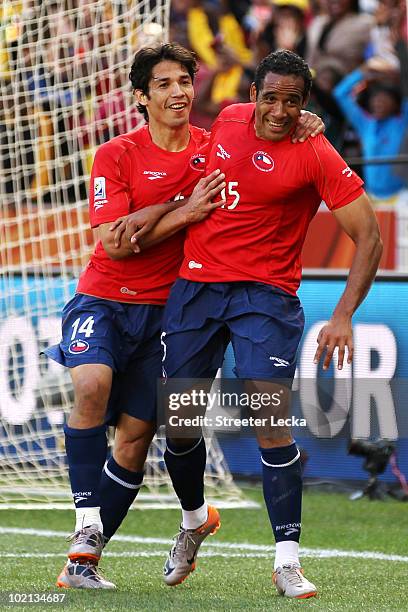 Jean Beausejour of Chile celebrates scoring the opening goal with team mate Matias Fernandez during the 2010 FIFA World Cup South Africa Group H...