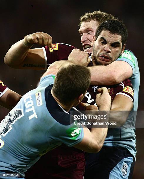 Greg Inglis of the Maroons clashes with Beau Scott of the Blues during game two of the ARL State of Origin Series between the New South Wales Blues...