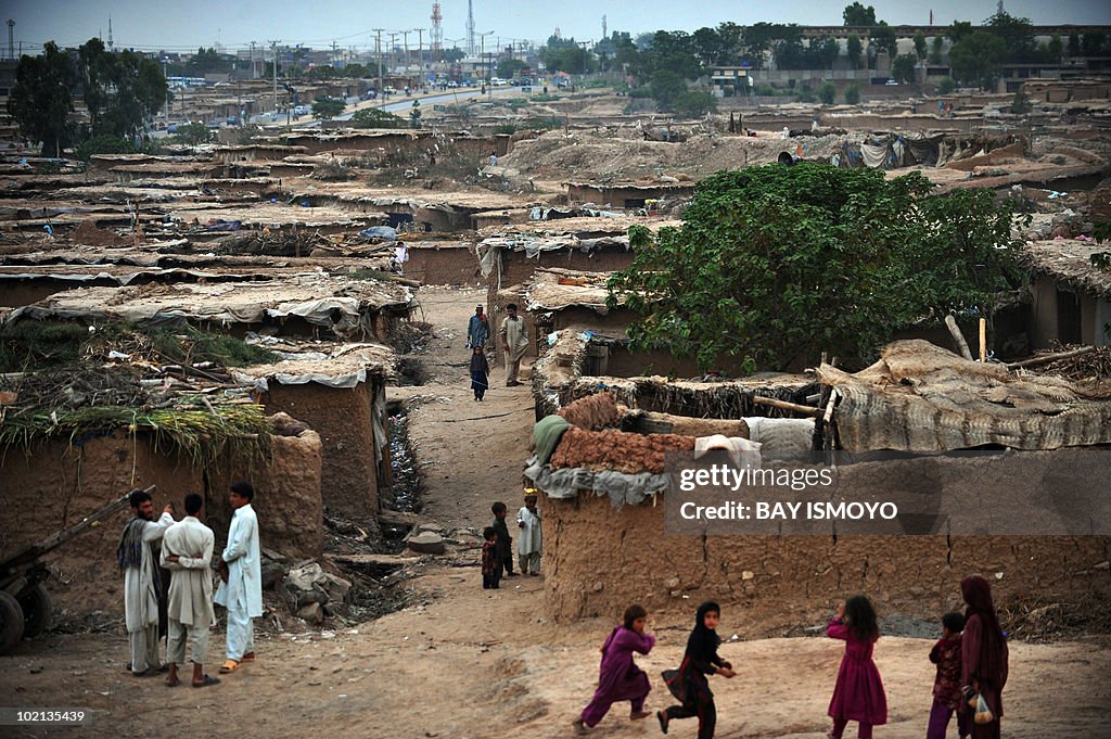 Children play near a slum area in Islama