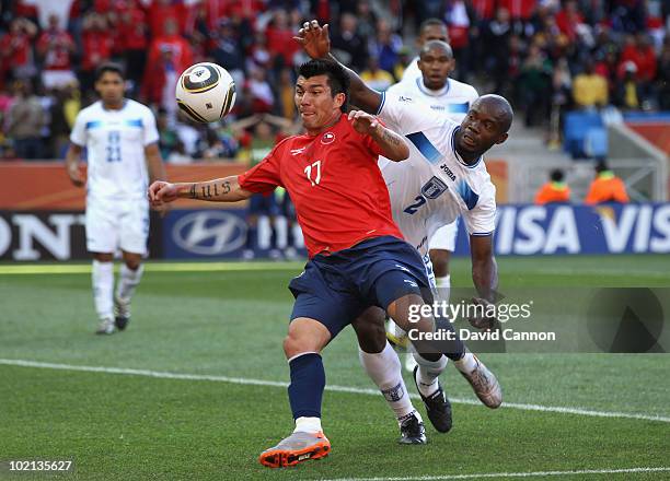 Gary Medel of Chile is challenged by Osman Chavez of Honduras during the 2010 FIFA World Cup South Africa Group H match between Honduras and Chile at...
