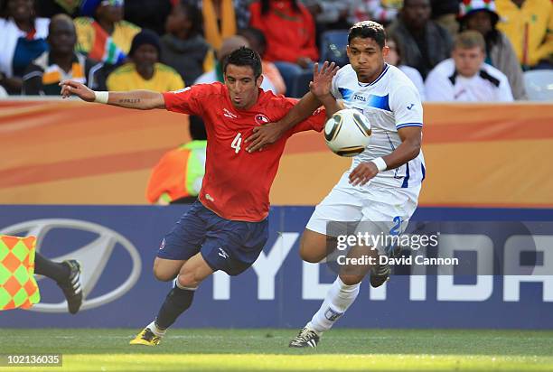 Mauricio Isla of Chile and Osman Chavez of Honduras battle for the ball during the 2010 FIFA World Cup South Africa Group H match between Honduras...