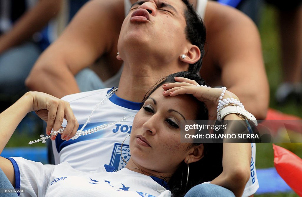 Honduran football fans react after their