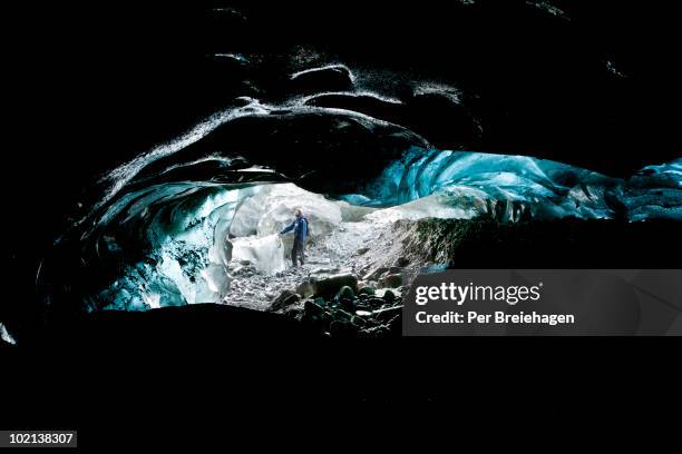 a glacier guide underneath the kennicot glacier - one per stock pictures, royalty-free photos & images