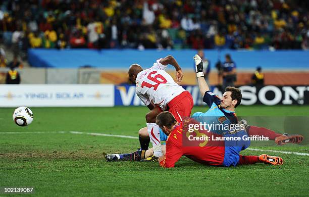 Gelson Fernandes of Switzerland breaks through Gerard Pique and Iker Casillas of Spain to score the first goal during the 2010 FIFA World Cup South...