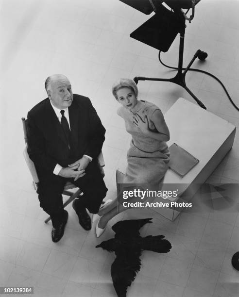 Director Alfred Hitchcock and leading lady Tippi Hedren pose with a stuffed raven on the set of the film 'The Birds, 1963.