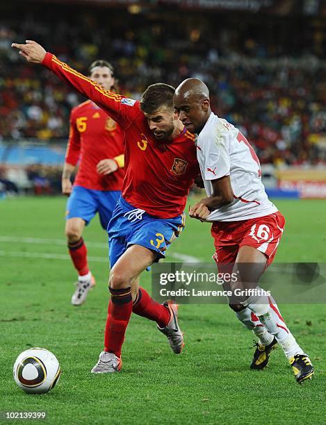 Gerard Pique of Spain clashes with Gelson Fernandes of Switzerland during the 2010 FIFA World Cup South Africa Group H match between Spain and...