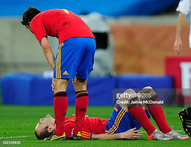 David Villa of Spain attends to his team mate Andres Iniesta as he lies on the ground injured during the 2010 FIFA World Cup South Africa Group H...