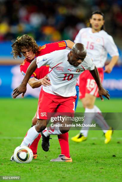 Blaise Nkufo of Switzerland is tackled by Carles Puyol of Spain during the 2010 FIFA World Cup South Africa Group H match between Spain and...