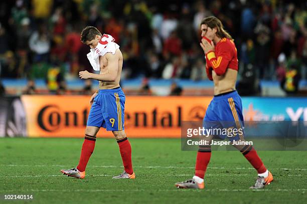 Fernando Torres and Sergio Ramos of Spain leave the field dejected after defeat in the 2010 FIFA World Cup South Africa Group H match between Spain...