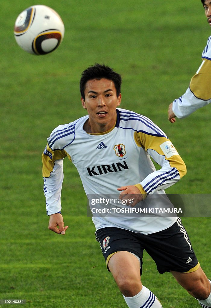 Japan's midfielder Makoto Hasebe chases