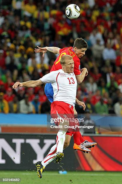 Fernando Torres of Spain and Stephane Grichting of Switzerland go up for a header during the 2010 FIFA World Cup South Africa Group H match between...