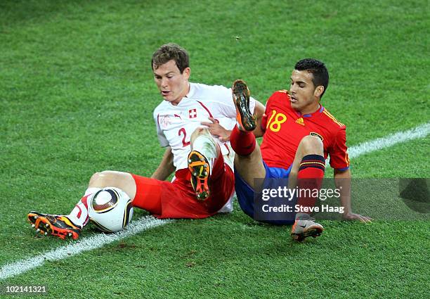 Stephan Lichtsteiner of Switzerland and Pedro Rodriguez of Spain tusle for the ball during the 2010 FIFA World Cup South Africa Group H match between...