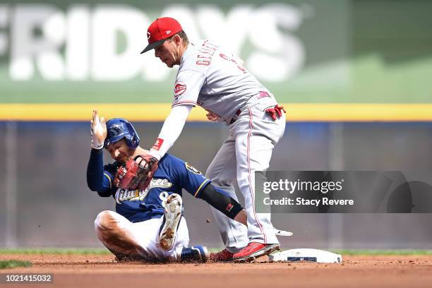 Ryan Braun of the Milwaukee Brewers is tagged out at second base by Scooter Gennett of the Cincinnati Reds during the second inning of a game at...