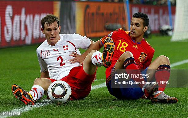 Stephan Lichtsteiner of Switzerland and Pedro Rodriguez of Spain battle for the ball during the 2010 FIFA World Cup South Africa Group H match...