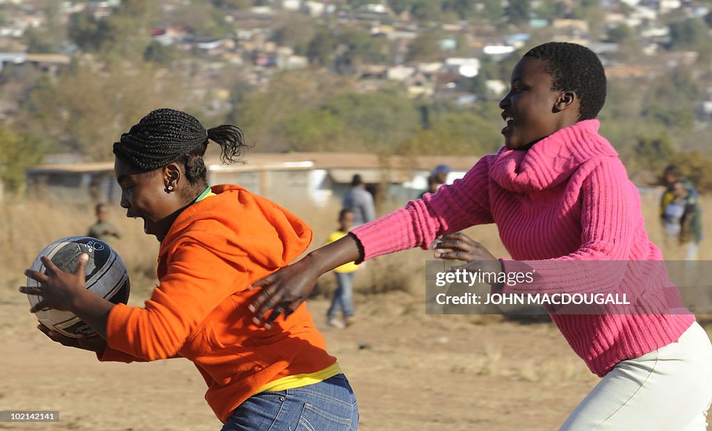 South African youths play with a ball at
