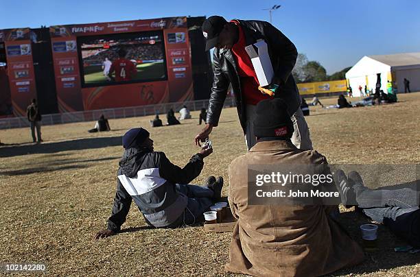 Awareness worker Tshegrfatso Dolo distributes condoms to fans during a soccer World Cup match at a fan park on June 16, 2010 in Soweto, Johannesburg,...