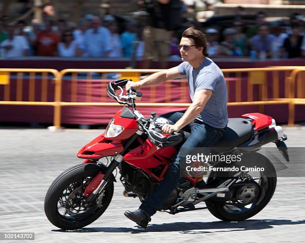 Actor Tom Cruise rides a motorcycle for the official "Knight and Day" movie stunt exhibition prior the world premier tomorrow night, next to...