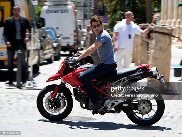 Actor Tom Cruise rides a motorcycle for the official "Knight and Day" movie stunt exhibition prior the world premier tomorrow night, next to...