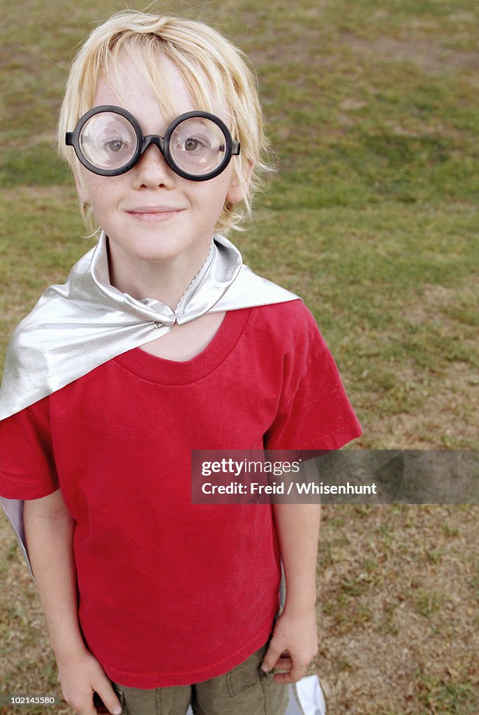 Boy wearing goggles and cape