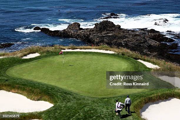 Tom Watson walks to the seventh green with his son/caddie Michael during a practice round prior to the start of the 110th U.S. Open at Pebble Beach...