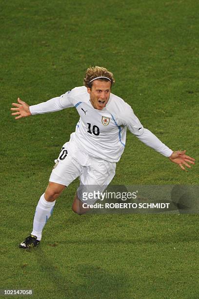 Uruguay's striker Diego Forlan celebrates after scoring the opening goal during the Group A first round 2010 World Cup football match South Africa...