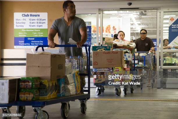 Crowds of people with overweighted shopping carts leave Sam's Club after buying her supplies for Hurricane Lane on Wedesday, August 22, 2018 in...