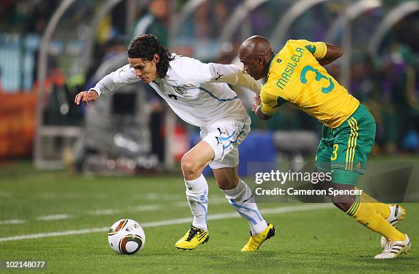 Edinson Cavani of Uruguay is challenged by Tsepo Masilela of South Africa during the 2010 FIFA World Cup South Africa Group A match between South...