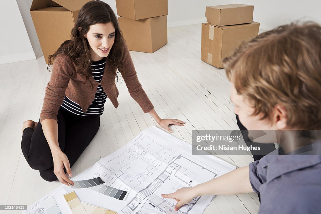 Couple looking at floorplan and paint swatches