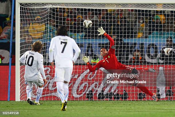 Diego Forlan of Uruguay shoots and scores a penalty against substitute goalkeeper Moneeb Josephs of South Africa during the 2010 FIFA World Cup South...