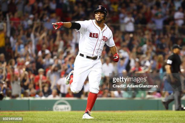 Xander Bogaerts of the Boston Red Sox points towards the dugout after hitting a solo home run in the fourth inning of a game against the Cleveland...