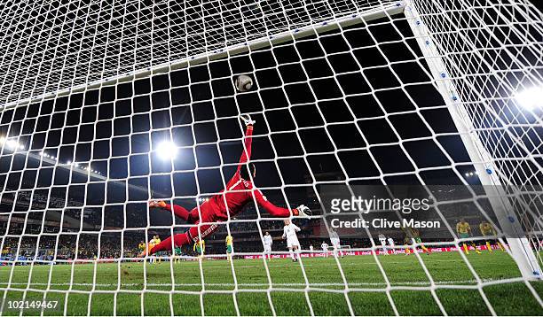 Diego Forlan of Uruguay shoots and scores a penalty against substitute goalkeeper Moneeb Josephs of South Africa during the 2010 FIFA World Cup South...