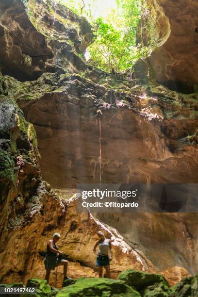 two persons and a cavern - höhlenforscher stock-fotos und bilder